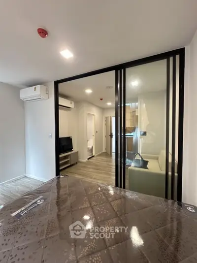Modern apartment interior with glass partition and air conditioning