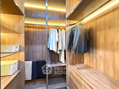 Spacious walk-in closet with wooden shelves and ample hanging space