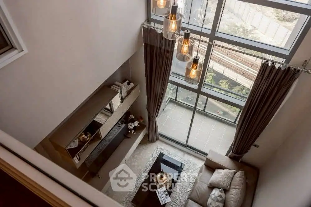Stunning loft-style living room with floor-to-ceiling windows and elegant decor.