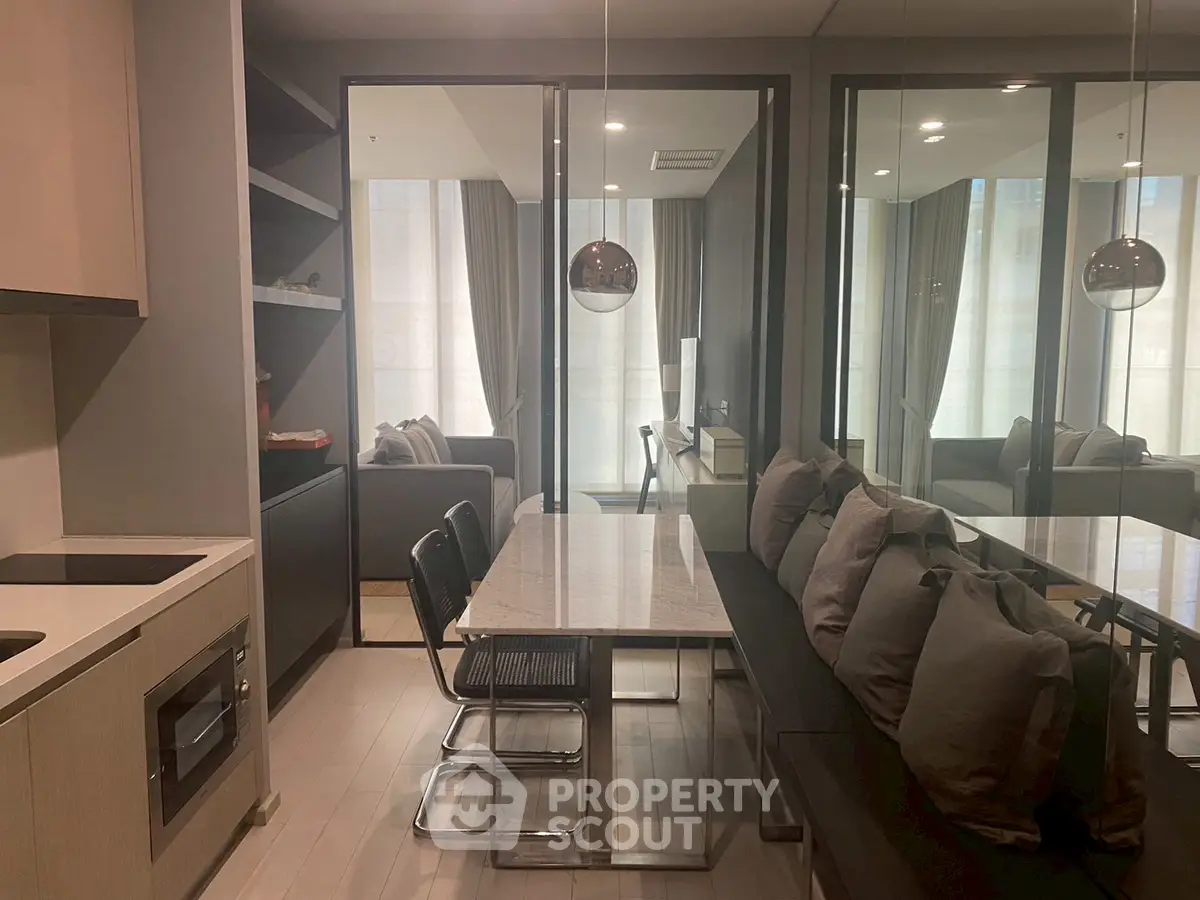 Modern dining area with sleek design and cozy seating in a contemporary apartment.