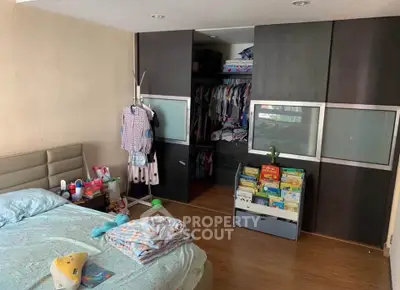 Spacious bedroom with sliding closet doors and cozy decor