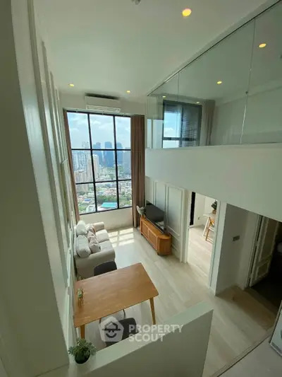 Modern loft apartment with floor-to-ceiling windows and stunning city view