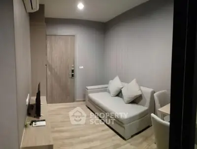 Modern living room with sleek furniture and wooden flooring, perfect for cozy urban living.