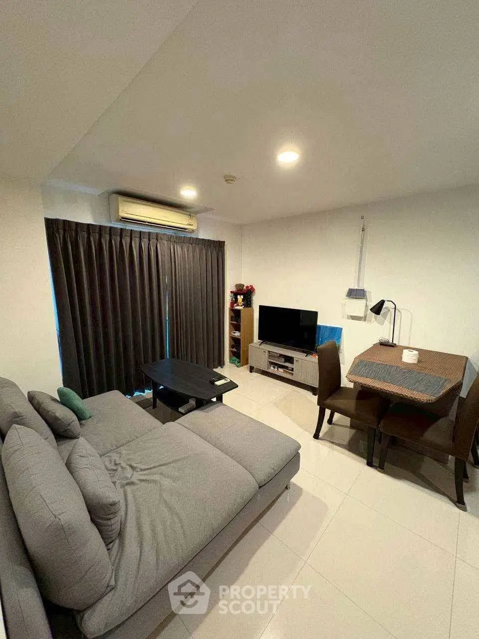 Cozy living room with modern furniture and dining area, perfect for relaxation and entertainment.