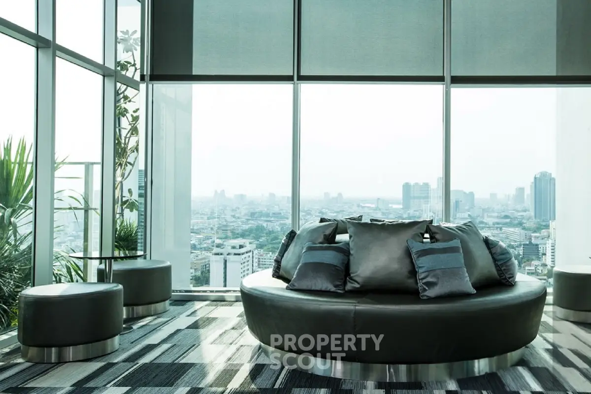 Luxurious high-rise living room with panoramic city views and modern decor.