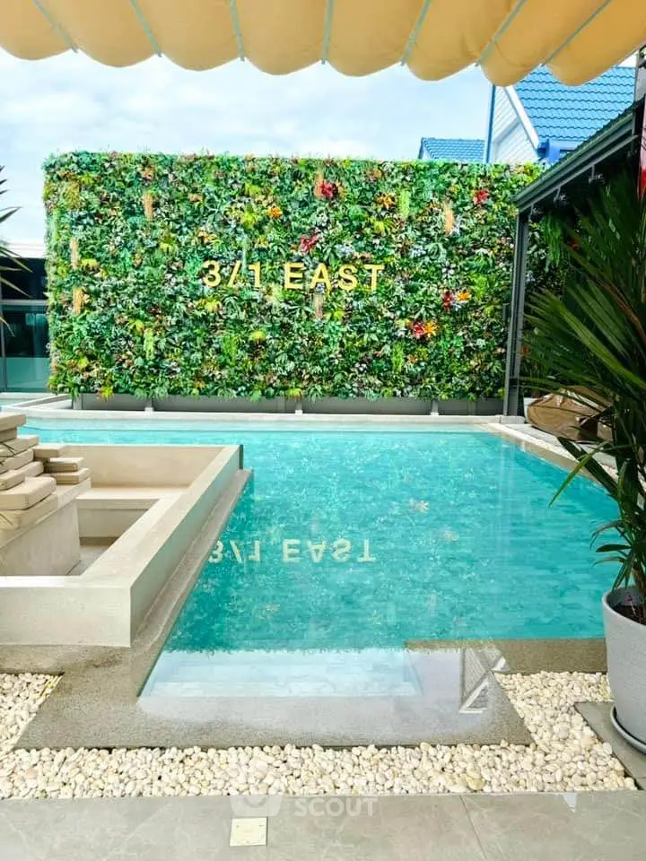 Luxurious pool area with vertical garden at 341 East, perfect for relaxation and entertainment.