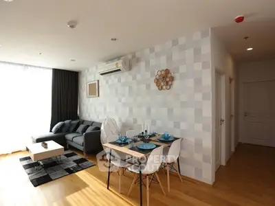 Modern living room with stylish decor and dining area, featuring natural light and contemporary furniture.