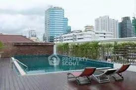 Luxurious rooftop pool with city skyline view, perfect for relaxation and leisure in urban setting.