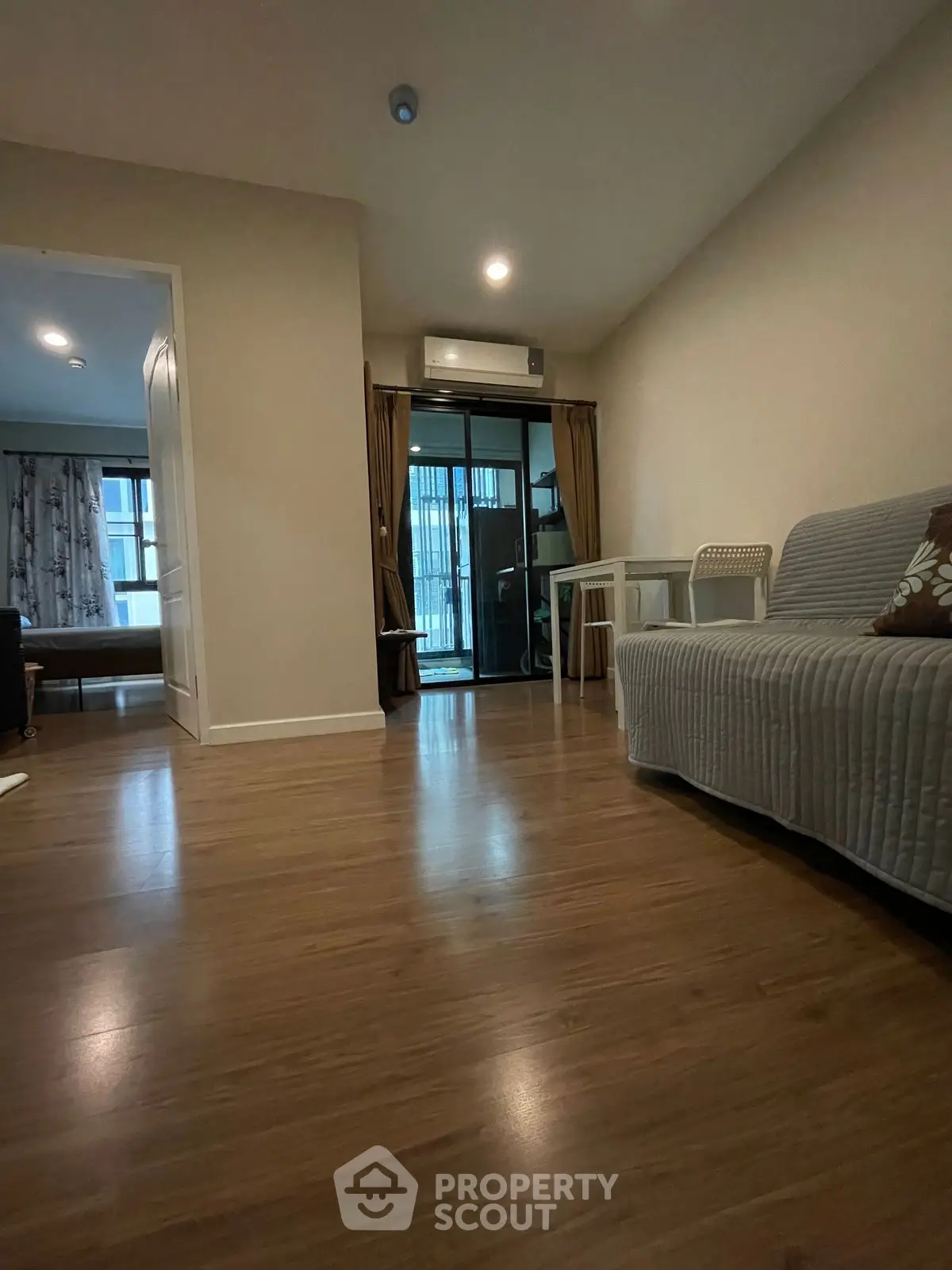 Cozy living room with wooden flooring and modern furniture in a stylish apartment.