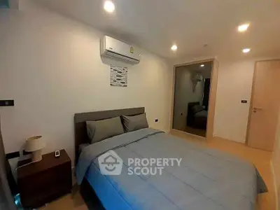Cozy bedroom with modern decor and air conditioning in a stylish apartment.