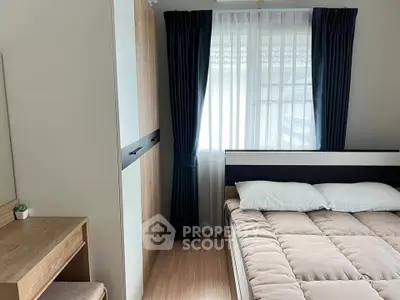 Cozy bedroom with modern decor, featuring a comfortable bed, stylish wardrobe, and natural light through large window.