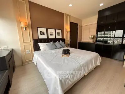 Modern bedroom with elegant decor and city view, featuring a cozy bed and stylish furnishings.