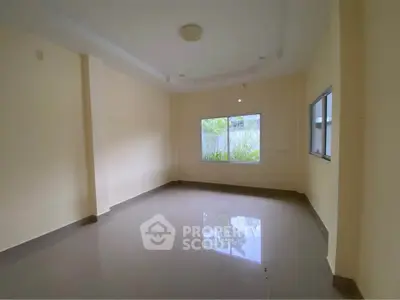 Spacious empty room with large window and glossy tiled floor