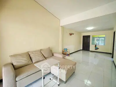Spacious living room with modern sofa and sleek tiled flooring