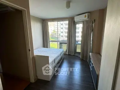 Bright bedroom with large windows and modern furnishings in urban apartment