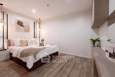 Elegant bedroom with modern decor, cozy lighting, and stylish wooden flooring, perfect for relaxation.