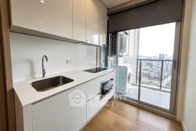 Modern kitchen with sleek cabinetry and city view from balcony