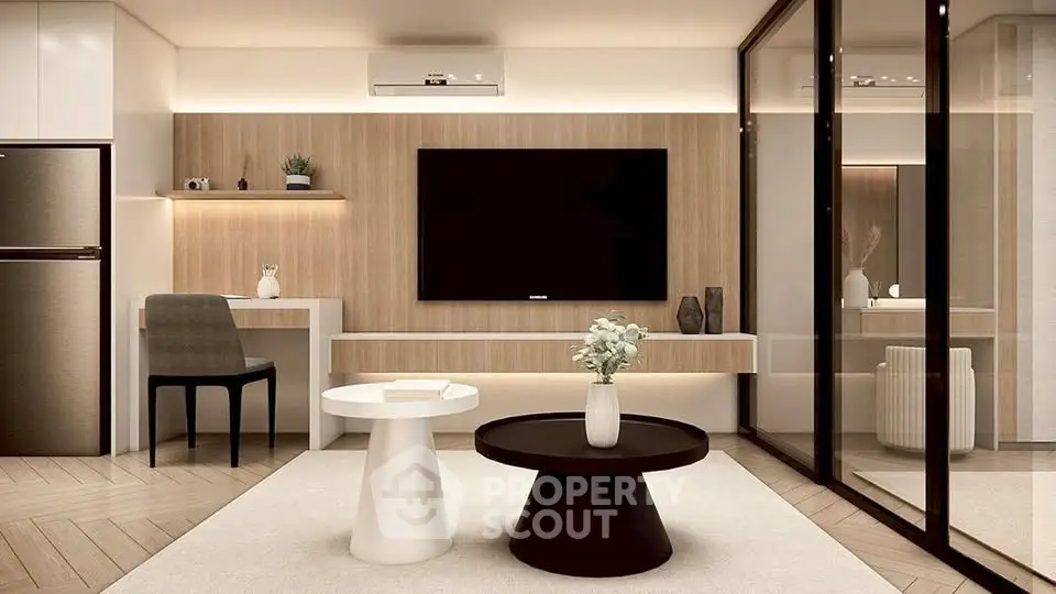 Modern living room with sleek furniture and large TV, featuring a stylish open layout.