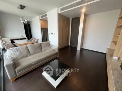 Modern living room with sleek furniture and dark wood flooring