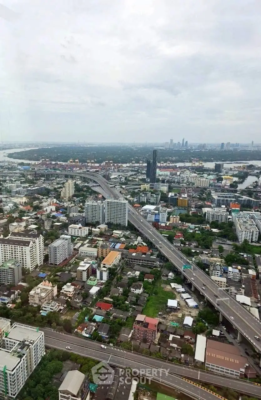Stunning aerial view of urban landscape with highways and skyscrapers, showcasing vibrant city life and development.