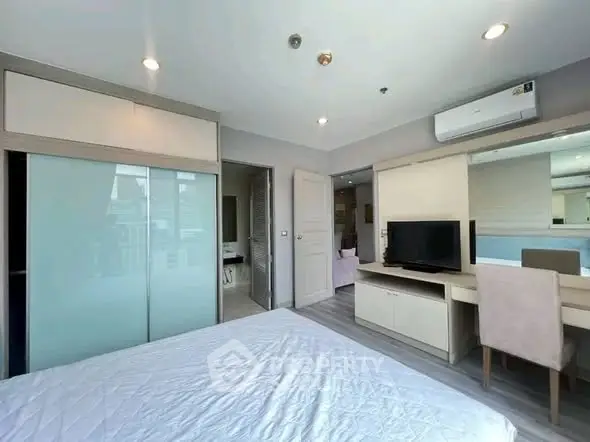 Modern bedroom with sleek design, featuring built-in wardrobe and stylish furniture, perfect for urban living.