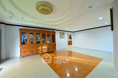 Spacious living room with elegant wooden cabinet and modern ceiling design