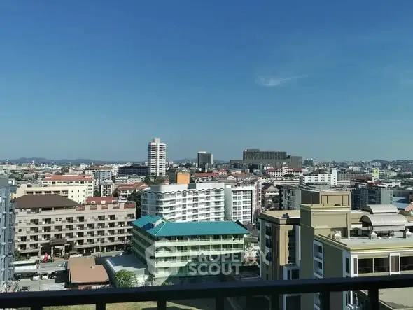 Stunning cityscape view from a high-rise balcony showcasing urban architecture and skyline.