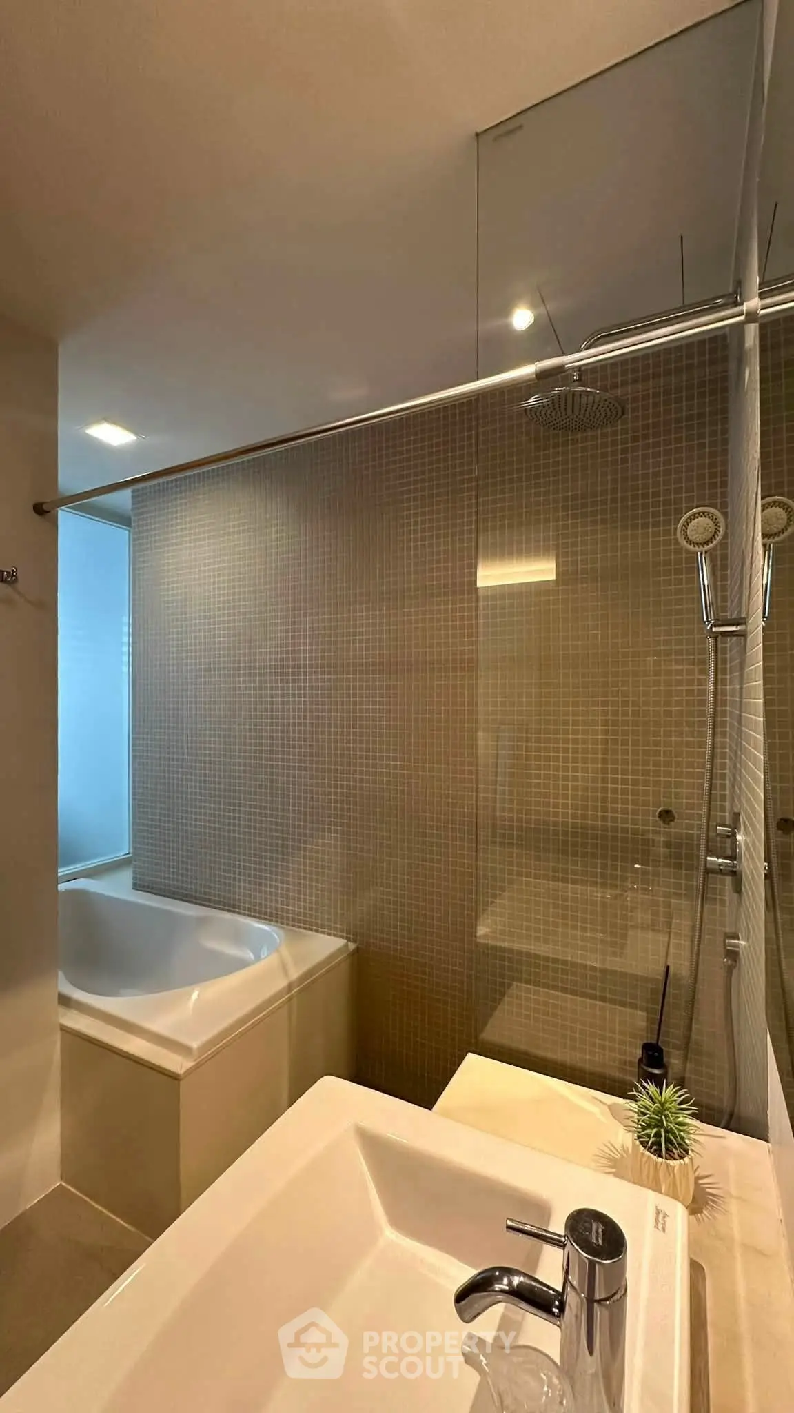 Modern bathroom with sleek shower and bathtub in contemporary apartment.