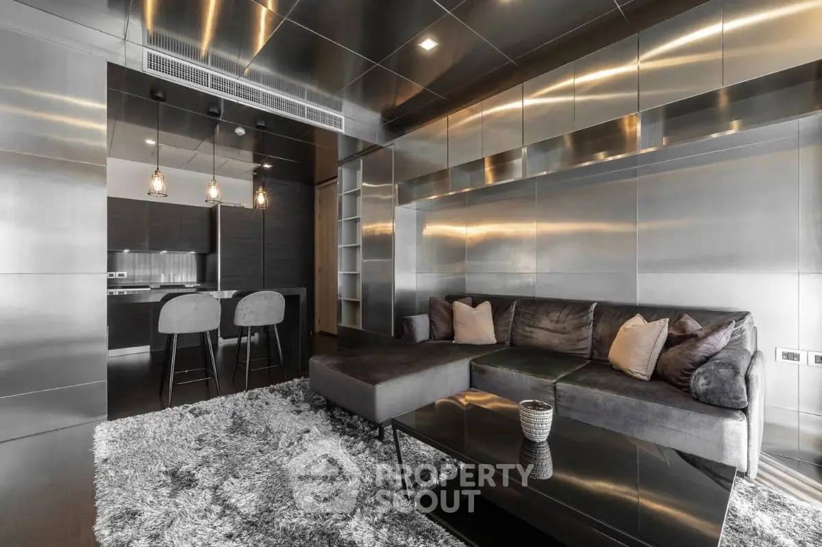 Luxurious modern living room with sleek metallic finishes and plush seating in a contemporary apartment.