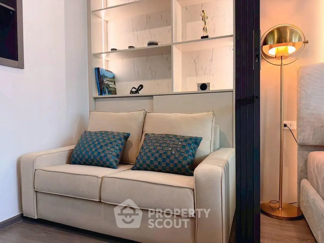 Cozy living room with stylish sofa and elegant lighting, perfect for relaxation and modern living.
