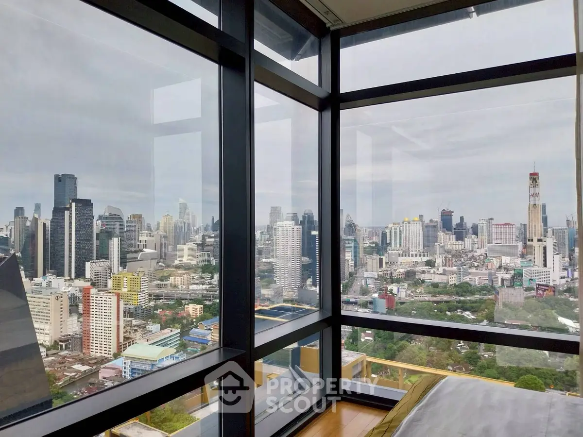 Stunning cityscape view from a modern high-rise apartment with floor-to-ceiling windows.