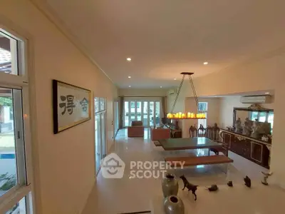 Spacious living room with elegant decor and large windows for natural light.