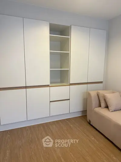 Modern living room with sleek storage cabinets and cozy sofa