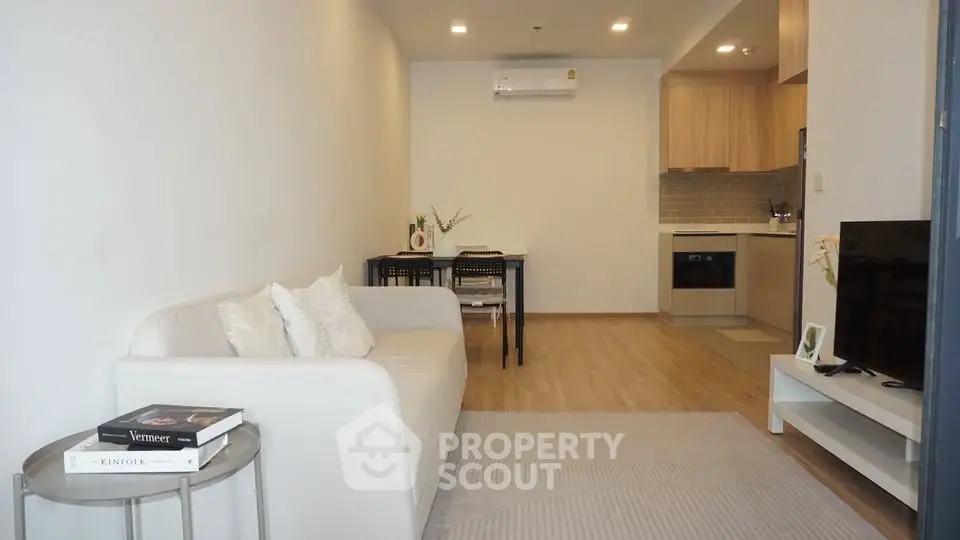 Modern living room with cozy sofa and open kitchen layout