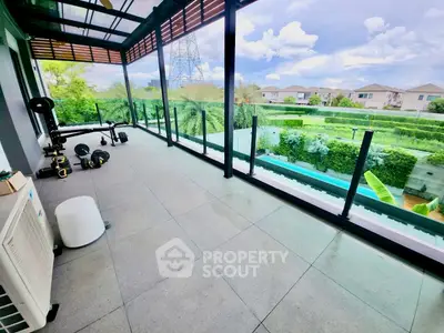 Spacious balcony with glass railing and scenic view in modern home