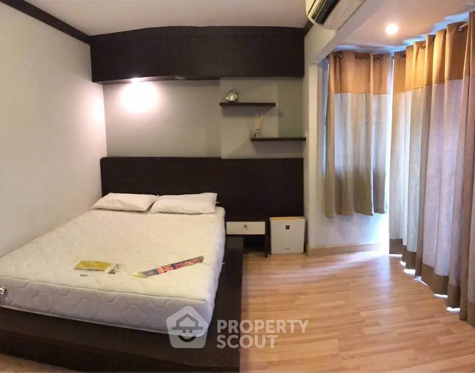 Cozy bedroom with wooden flooring and modern decor