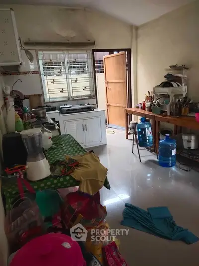 Cozy kitchen with open layout and ample natural light, featuring modern appliances and organized storage.