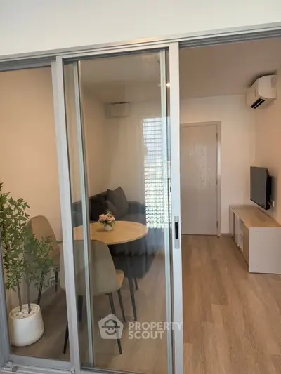 Modern living room with sliding glass door and cozy dining area