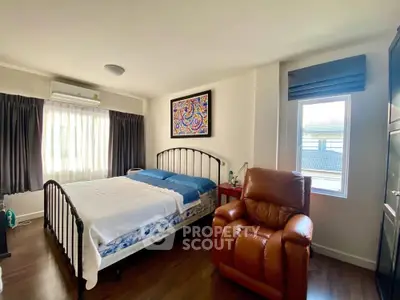 Spacious bedroom with modern decor and natural light