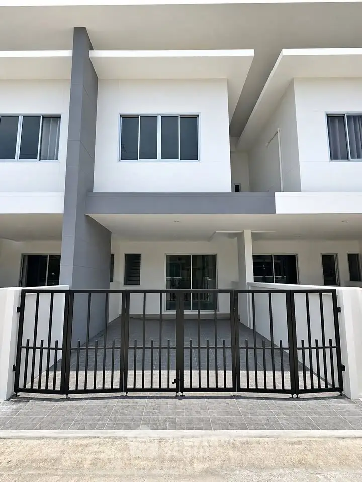 Modern townhouse exterior with sleek design and gated entrance, perfect for contemporary living.