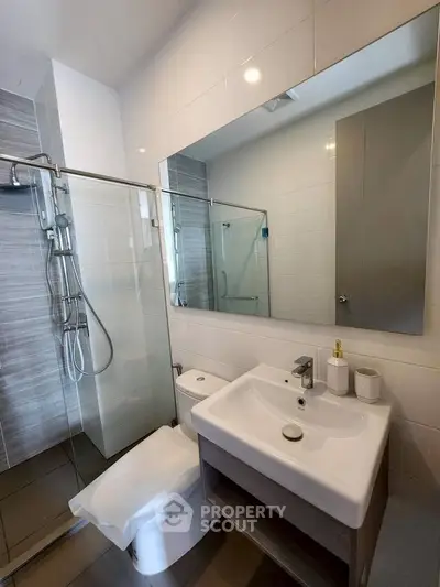 Modern bathroom with glass shower and sleek sink design