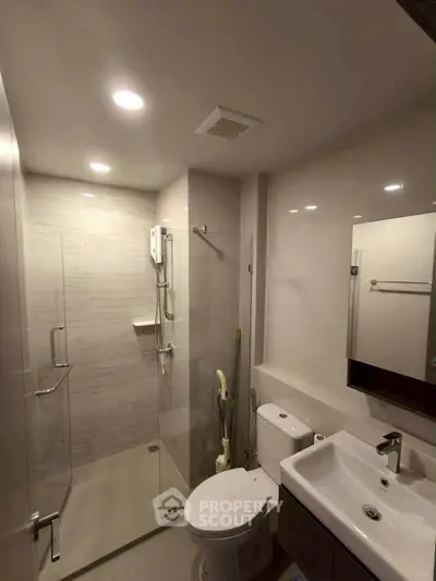 Modern bathroom with glass shower and sleek fixtures