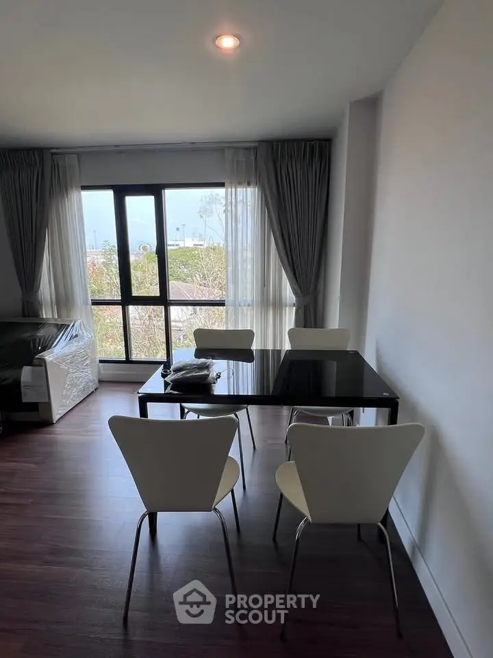 Modern living room with sleek dining area and large window view