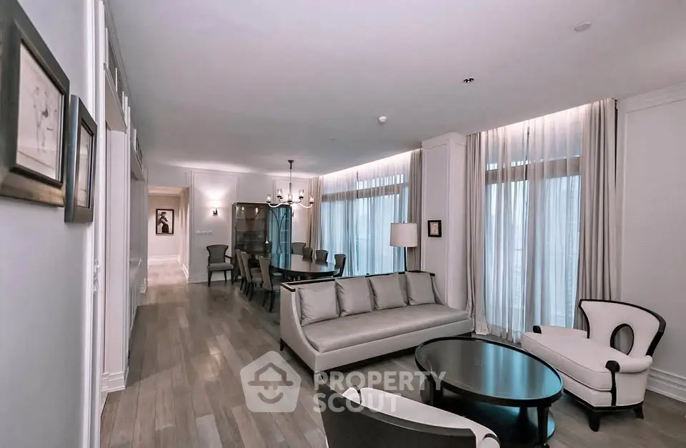Elegant living room with modern furniture and large windows in a luxury apartment.