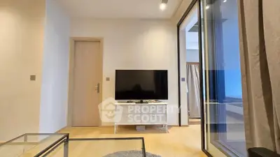 Modern living room with sleek TV setup and glass coffee table