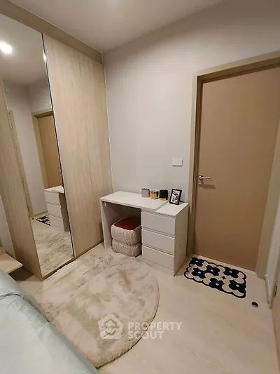 Cozy bedroom with mirrored wardrobe and modern decor
