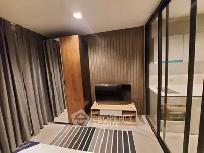 Modern bedroom with sleek design and adjacent kitchen view