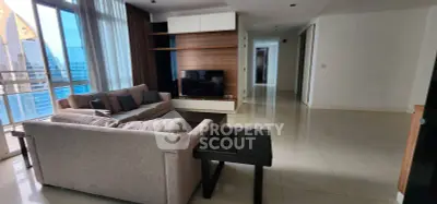 Spacious modern living room with large windows and city view