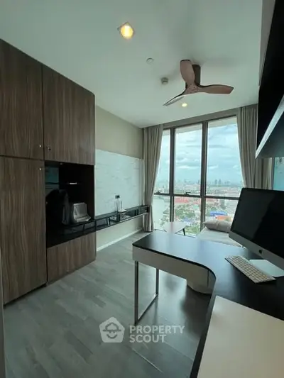 Modern study room with city view, sleek desk, and built-in storage cabinets.