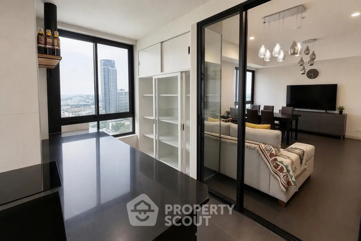 Modern open-layout apartment with city view, sleek kitchen, and stylish living area.